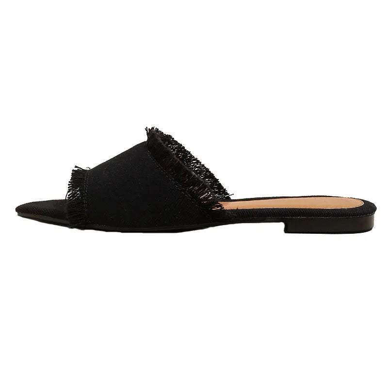 Women's apricot denim flat slippers with a tassel detail and leather lining.