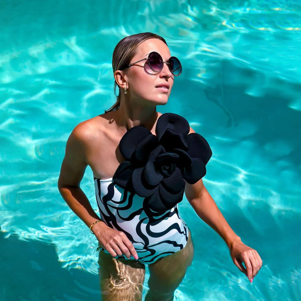 Close-up of a woman's one-piece swimsuit with a three-dimensional floral pattern and a contoured fit.