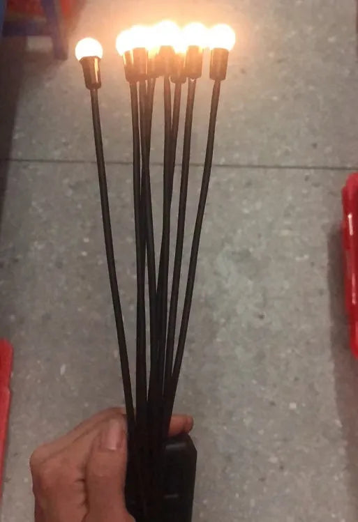 Solar-powered LED garden light with multiple heads on stainless steel ground spikes