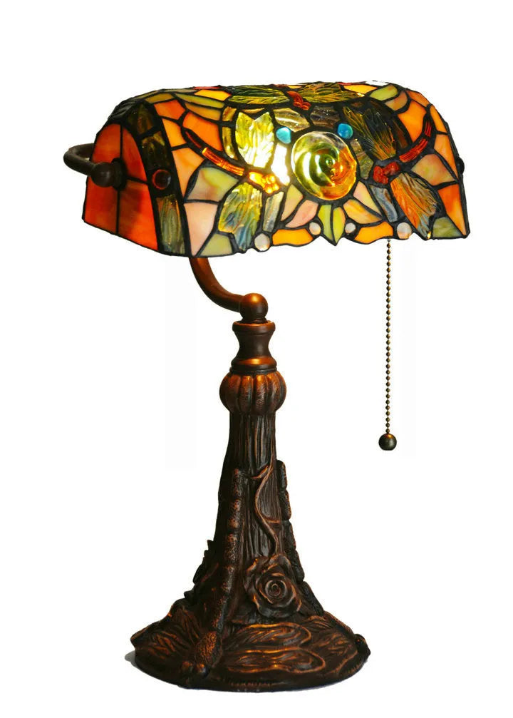 10-inch Tiffany stained glass table lamp on a desk with a warm glow.