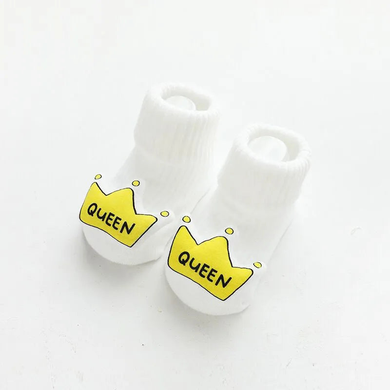 Baby socks with anti-slip glue dots on soles in combed cotton, showing mid-tube height and various colour options