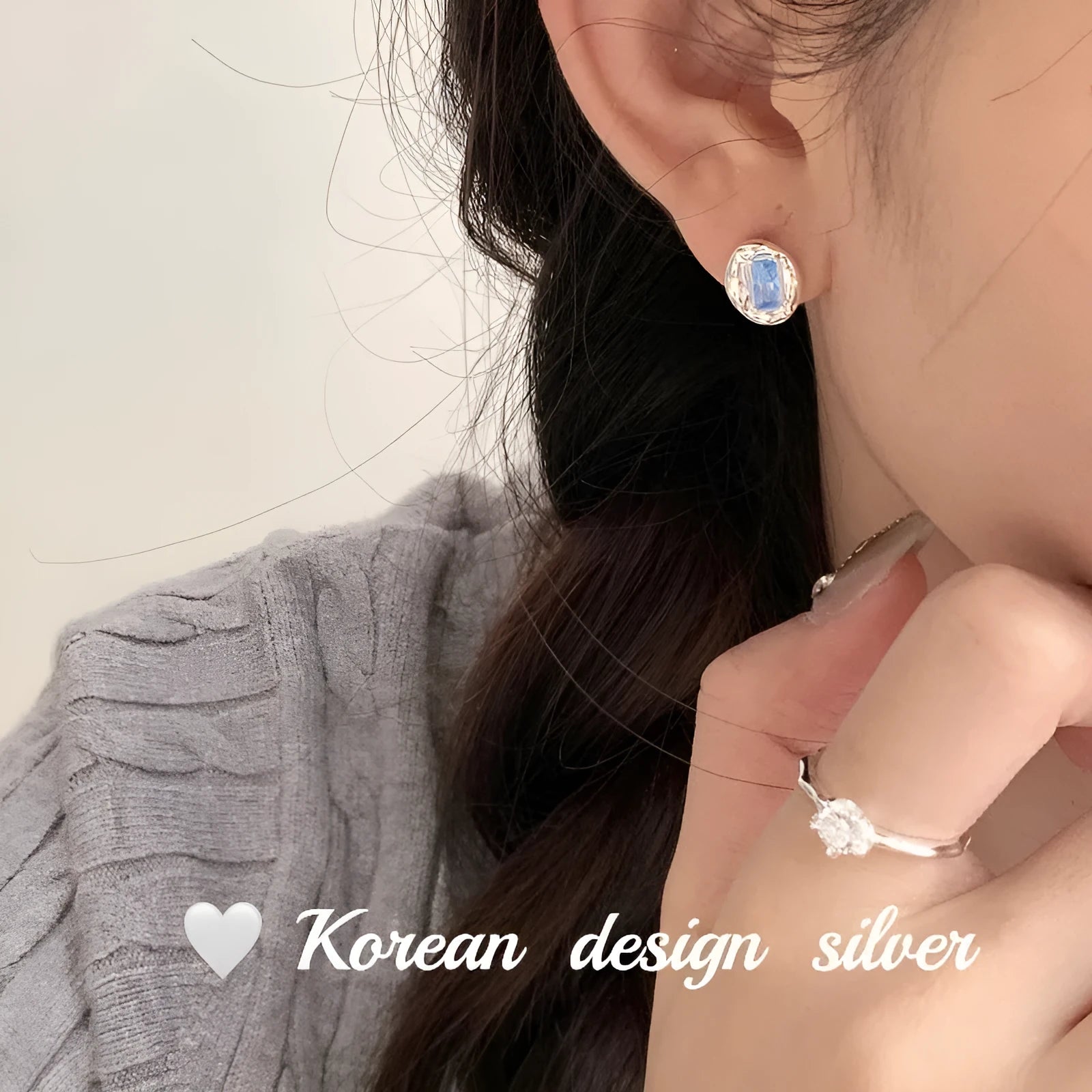 S925 sterling silver earrings with oval blue diamond heart-wrapped geometric design and electroplated silver finish