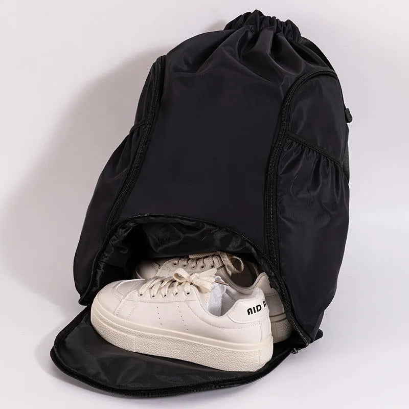 Cube-shaped sports backpack with drawstring closure in colour options including black, grey, green