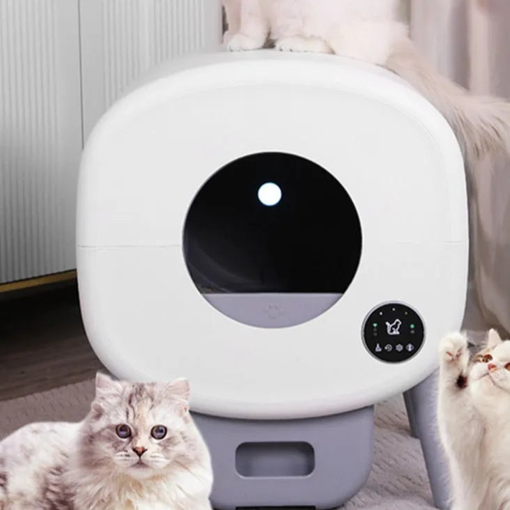 White intelligent automatic self-cleaning cat litter box with control panel, shown with deodorising tablets and cleaning brush.