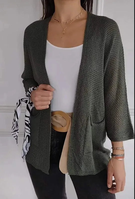 Women's army green waffle knit cardigan coat with nine-quarter length sleeves and pockets.