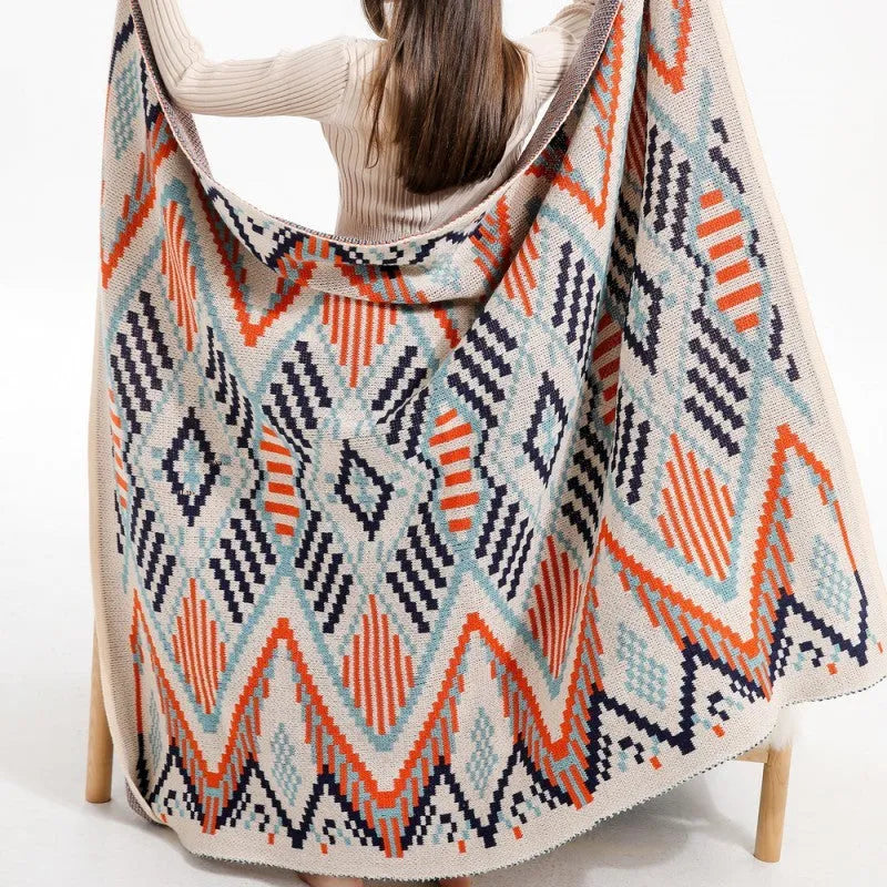 Bohemian style acrylic sofa cover blanket with tassel trim in a geometric pattern colour option.
