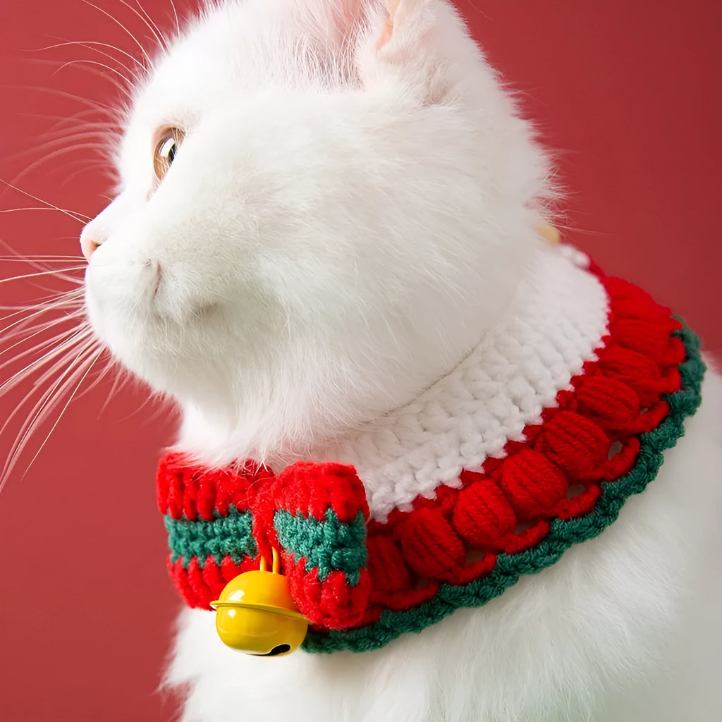 Hand knitted Christmas pet collar for cats made from milk cotton yarn with adjustable sizing and festive bow design