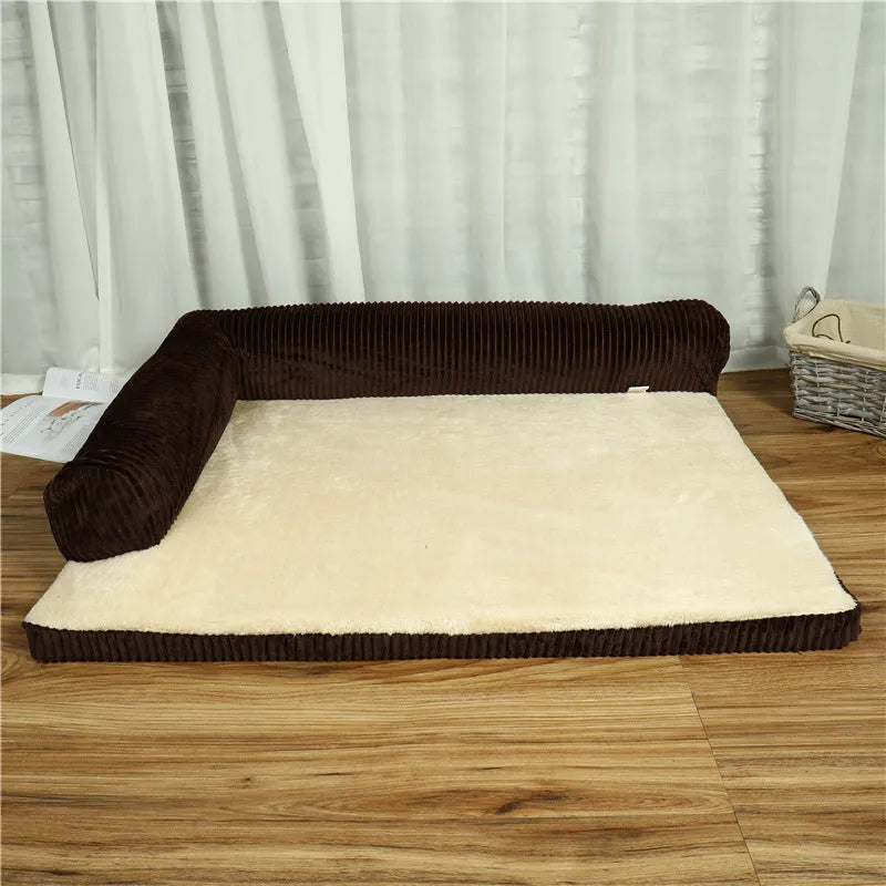 Grey corduroy pet sofa dog bed with bilateral bolsters and a non-slip cloth base on a wooden floor.