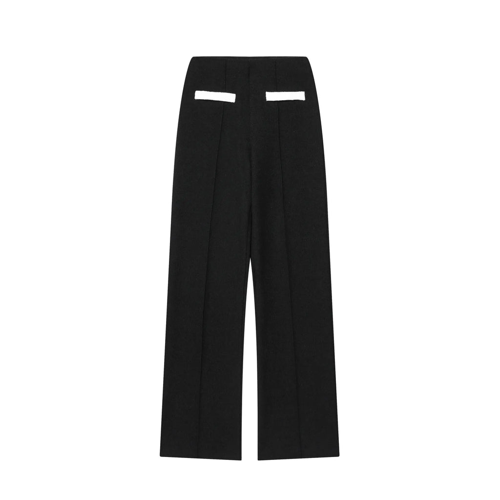 Women's casual suit set with a beaded leather round neck top and high-waisted trousers on a model.
