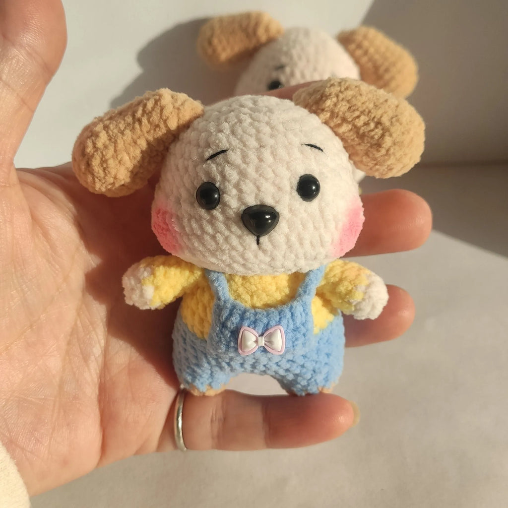 Handmade woollen zodiac dog pendant charm on a keychain, shown in pinafore dress style.