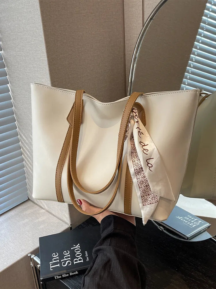 Soft large capacity tote bag with crossbody strap showing internal zipper compartment