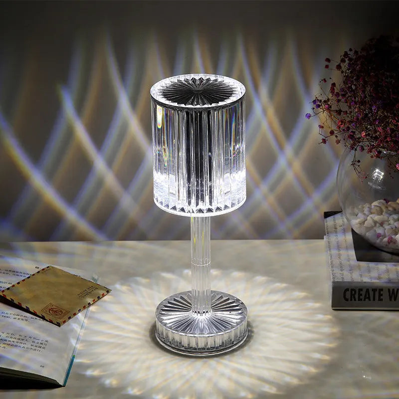 Modern crystal table lamp with a diamond-faceted shade on a metal stand, showing amber colour option.