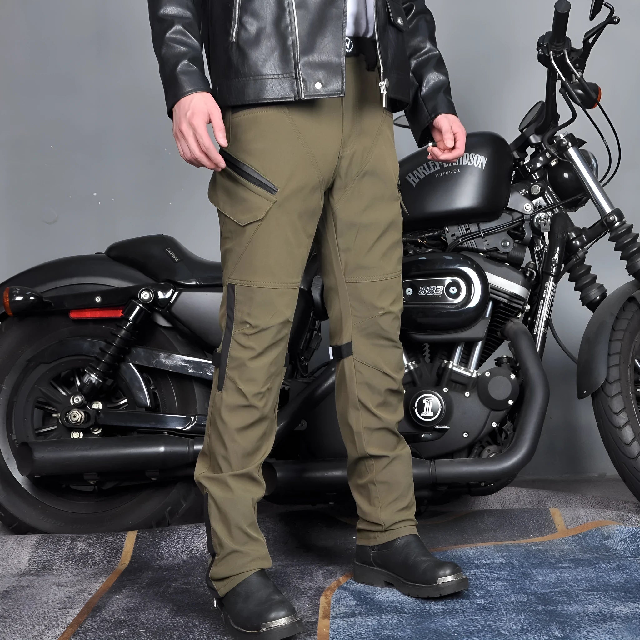 Men's solid-colour waterproof motorcycle trousers shown with a detachable belt and protective knee pads.