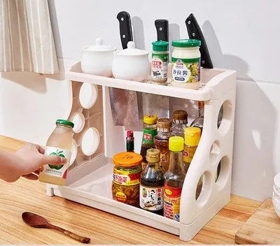 Foldable kitchen storage rack with multilayer shelves in white colour on countertop
