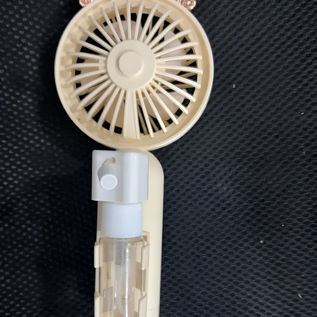 Compact plastic personal desk fan with adjustable nozzle and USB port, shown in apricot colour.