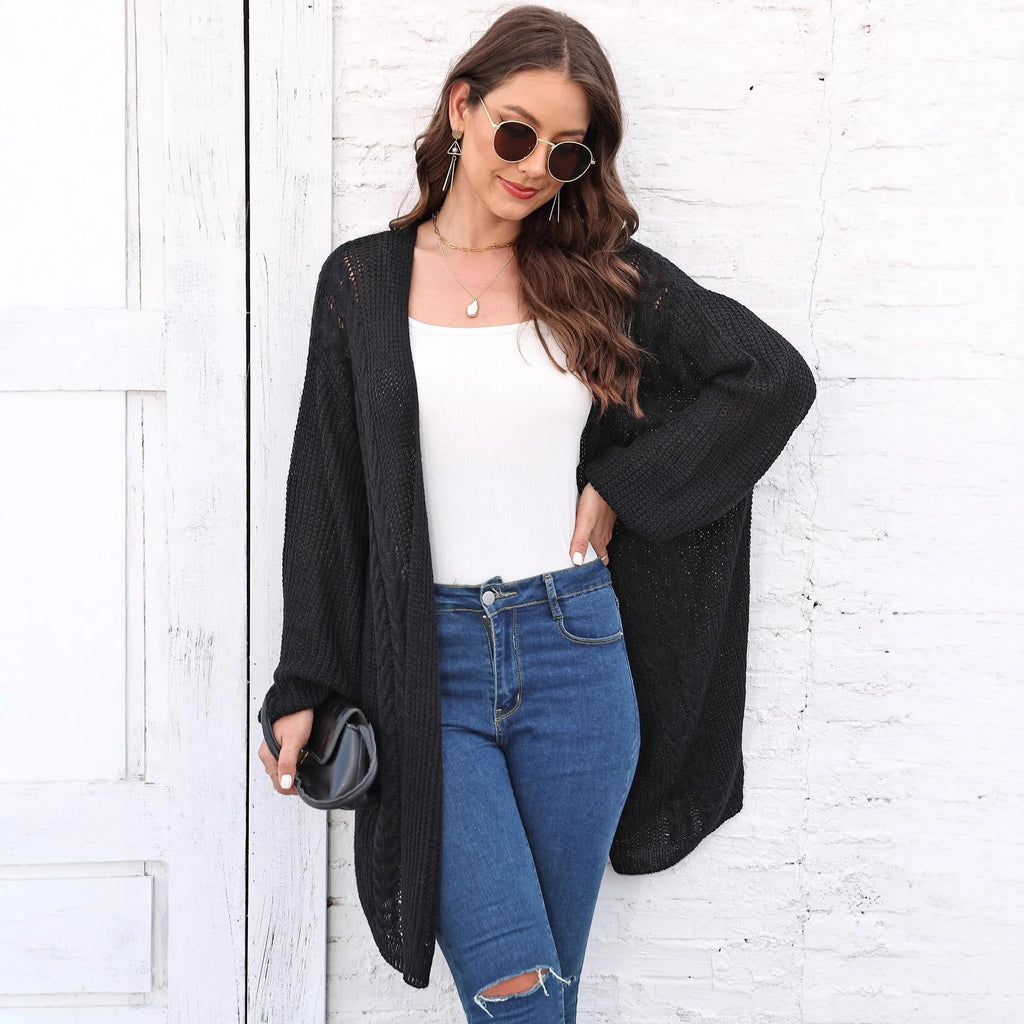 Women's loose-fitting solid colour acrylic sweater coat on a hanger