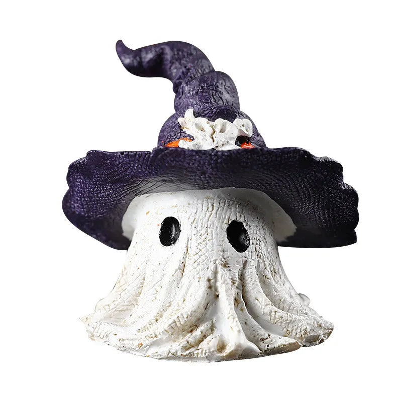 Close-up of a detailed black and a purple resin wizard hat ornament for holiday decoration.