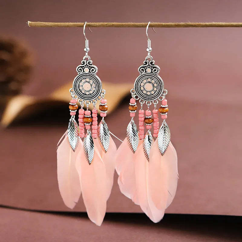 Round drop feather earrings in alloy with electroplated finish showing leaf shape and pattern details