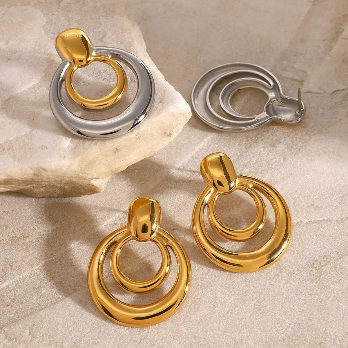 Round double-layer hollow stud earrings with 18K gold electroplated finish on titanium steel