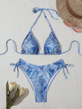 Denim blue printed women's bikini set with strap design on a mannequin.