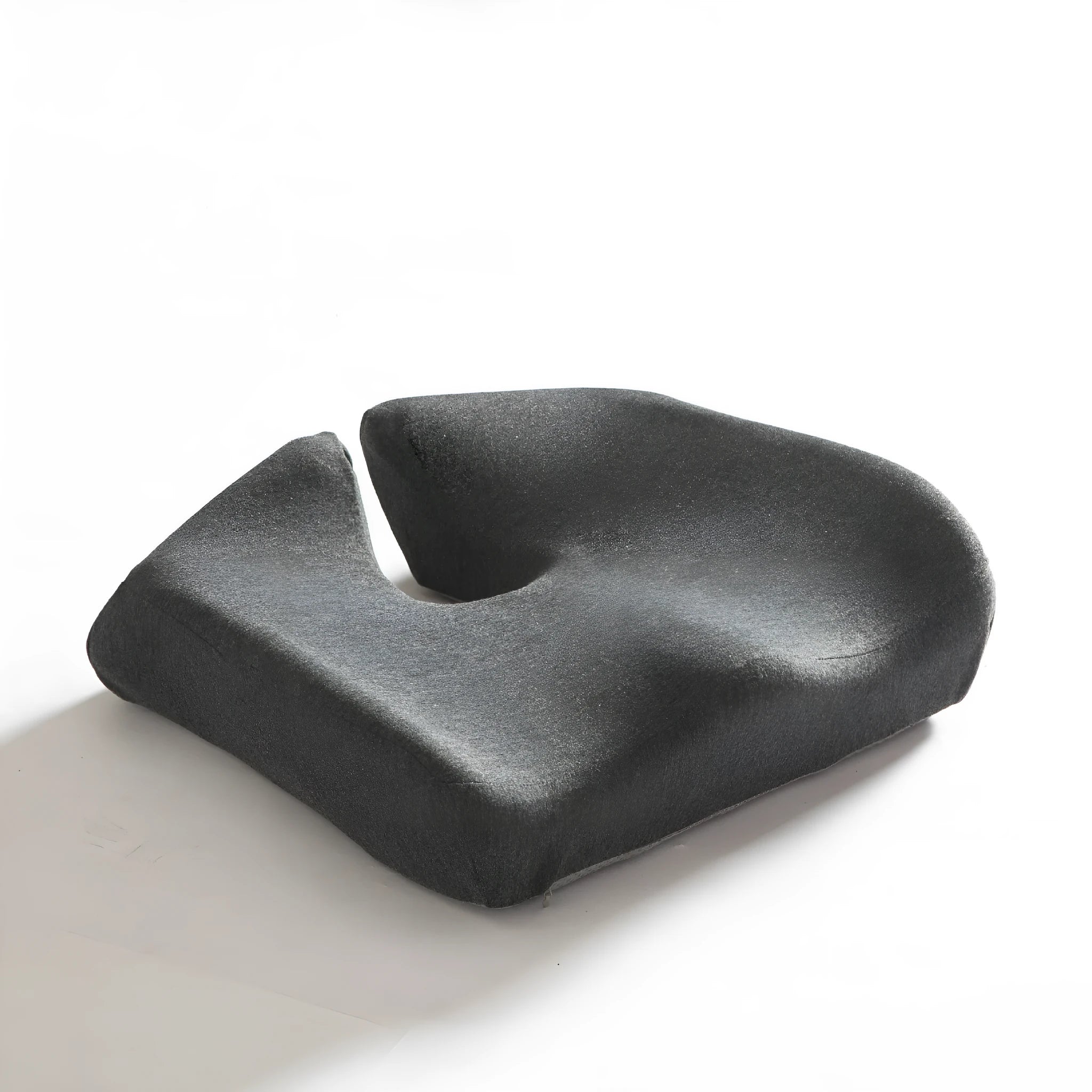 Black memory foam office chair cushion for waist support, shown on a desk chair.