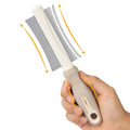 White double-sided pet grooming brush with curved design and comfort-grip handle for dogs and cats