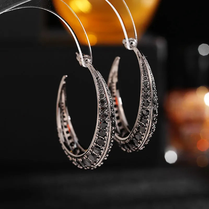 Women's large geometric copper hoop earrings in gold, silver, purple, green, or black.