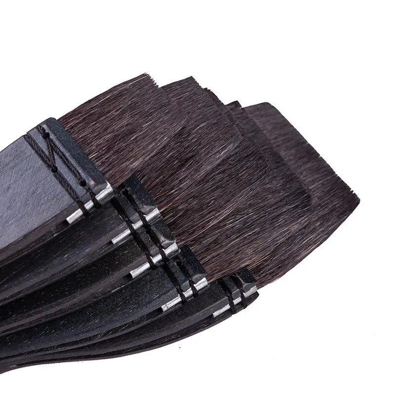 Set of five grey squirrel hair makeup brushes with wooden handles in different sizes from 30mm to 70mm wide.
