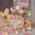 Battery-powered LED fairy lights with ten pink PV foam roses on a 1.5-metre wire for indoor decoration.