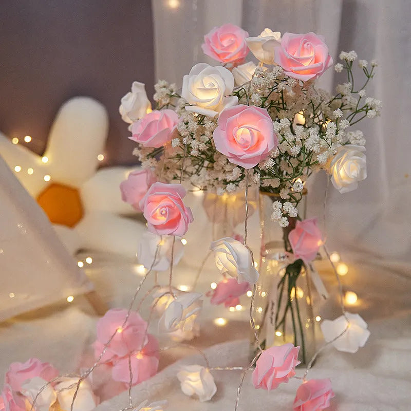 Battery-powered LED fairy lights with ten pink PV foam roses on a 1.5-metre wire for indoor decoration.