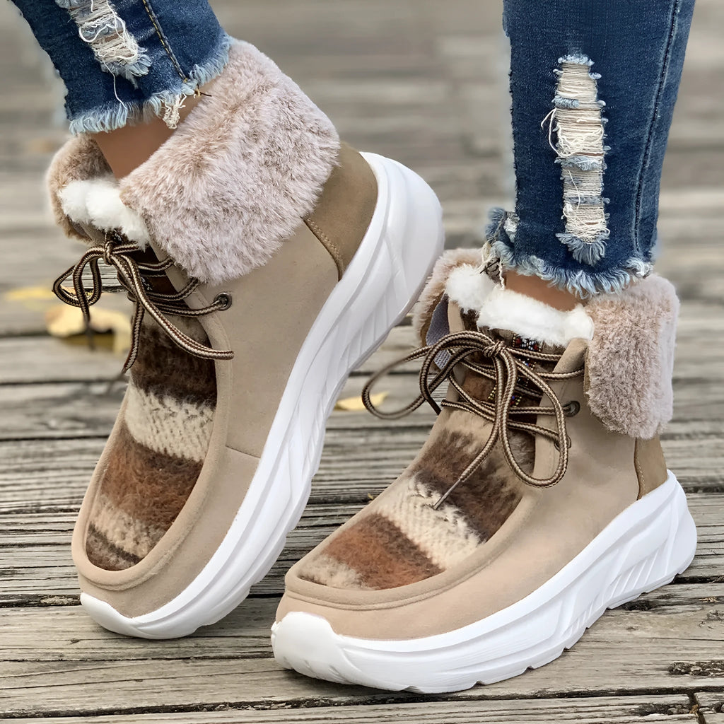 Women's beige suede lace-up snow boots with a thick platform sole and plush lining on a white background.