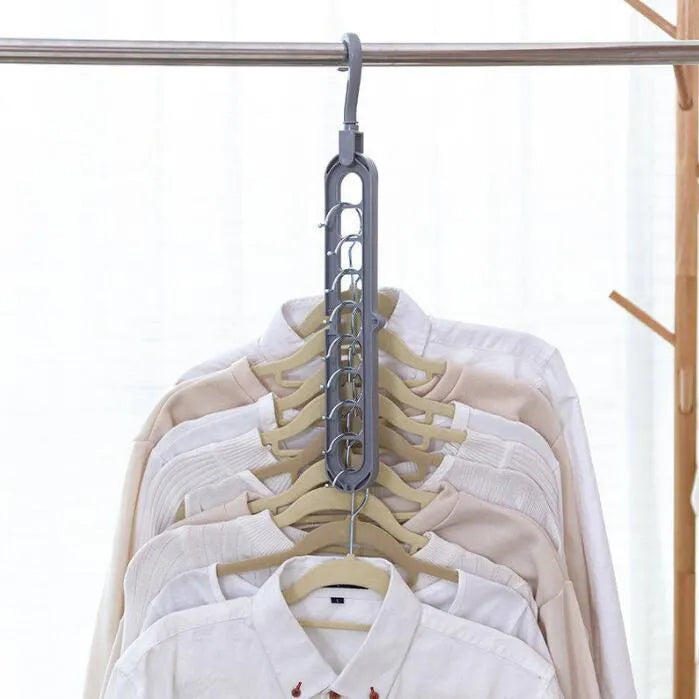 Pink plastic clothes hanger with a rotating hook on a white background.