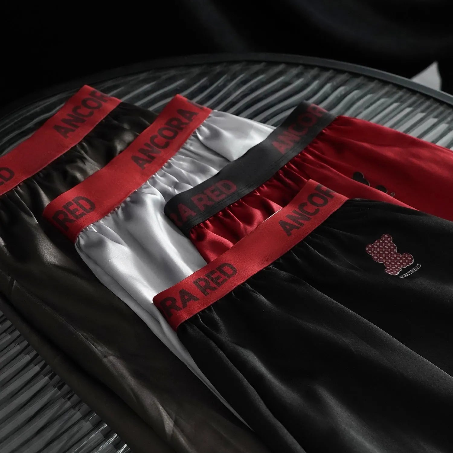 Solid colour men's boxer briefs in black, blue, brown, purple, red, and silver with mid waist design