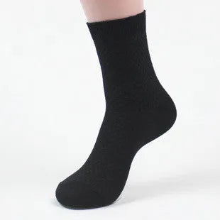 Men's bamboo fibre business socks in grey with a small-square pattern, shown on a foot.