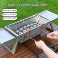 Small foldable steel charcoal grill for portable outdoor barbecues.