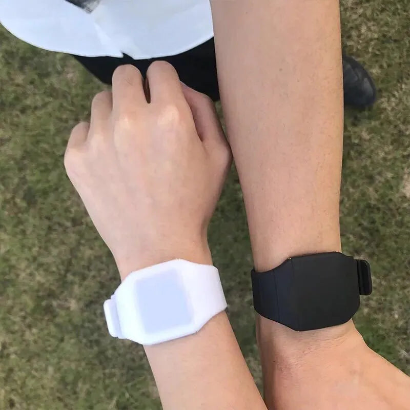 Square electronic touch screen watch showing numeric display on a coloured PU strap.