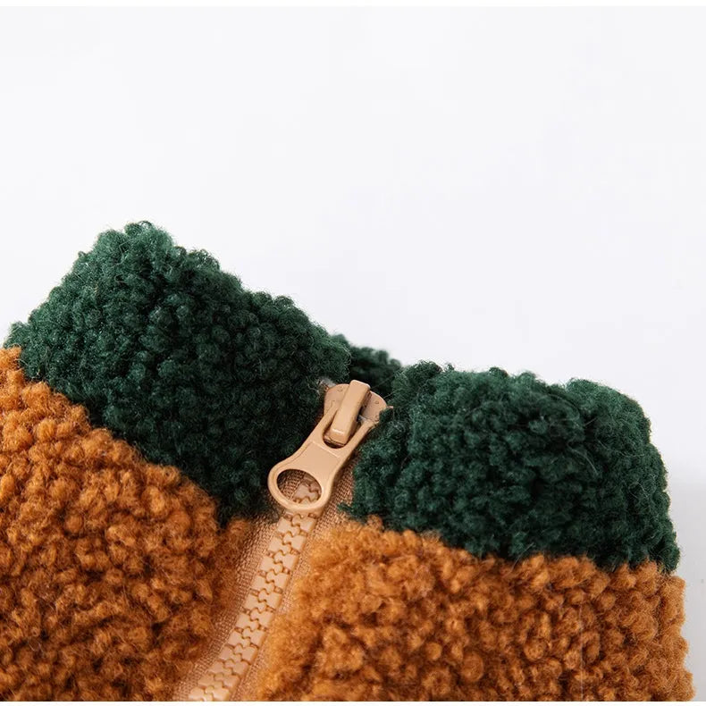 Colour-block pet fleece jacket with squirrel patch, leash ring, and pockets in green, brown, and beige on a small dog.
