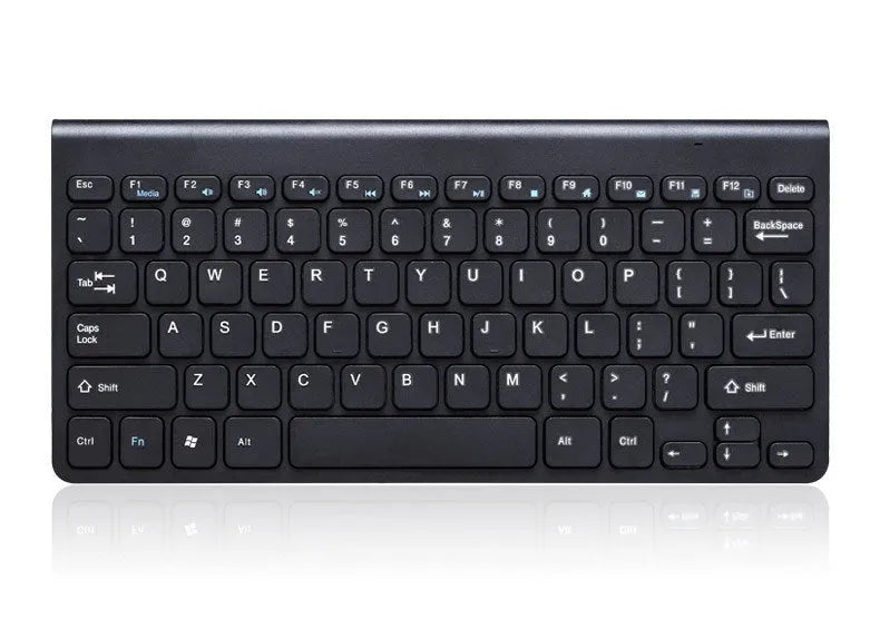 Black and white wireless keyboard and mouse set with USB receiver on a wooden desk.
