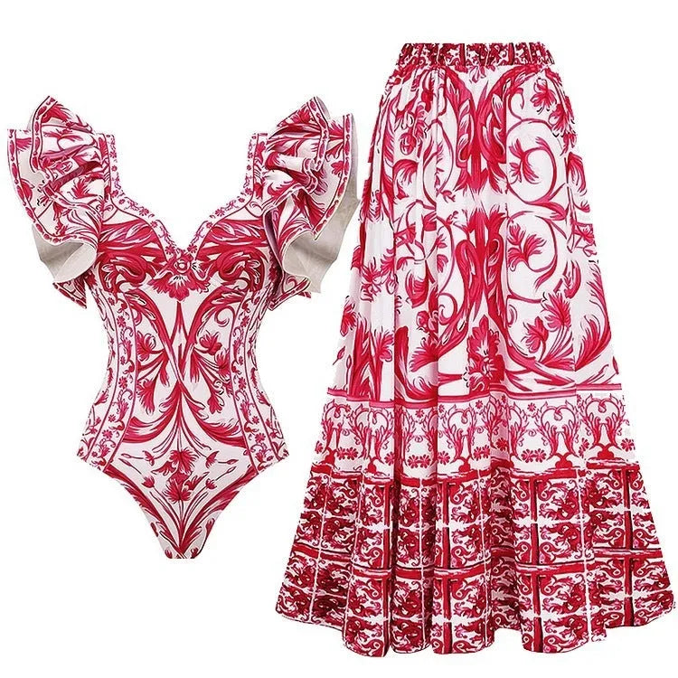 Women's printed one-piece swimsuit set with a matching cover-up skirt on a blue background.
