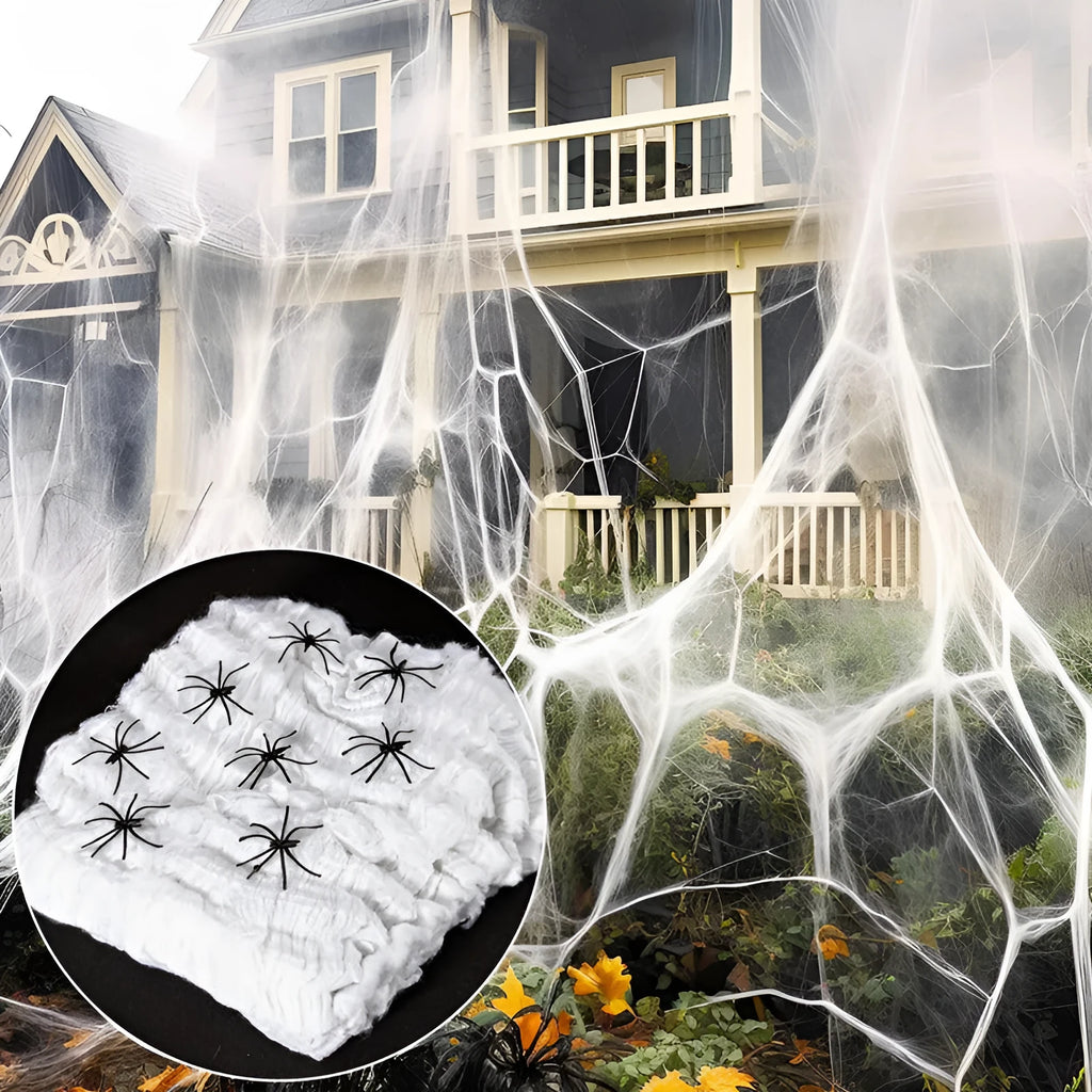 Halloween cotton spider web decoration with white plastic spiders on a dark background