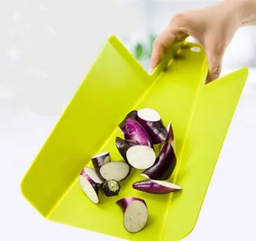 Green folding plastic cutting board with non-slip texture and hanging hole on kitchen countertop