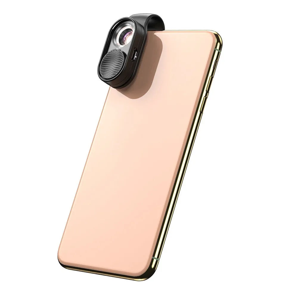 Black mobile magnification microscope with LED light clamped onto a smartphone, showing 100x magnification lens detail