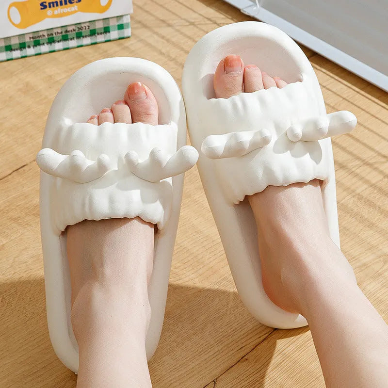 Deer horn design EVA flip flop slippers in light yellow on a white background.