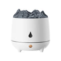 White volcano-shaped humidifier and aromatherapy diffuser on a table with USB cable.