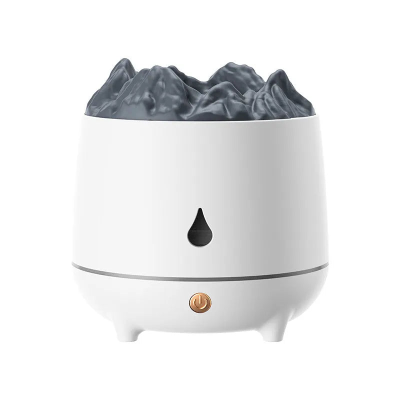 White volcano-shaped humidifier and aromatherapy diffuser on a table with USB cable.