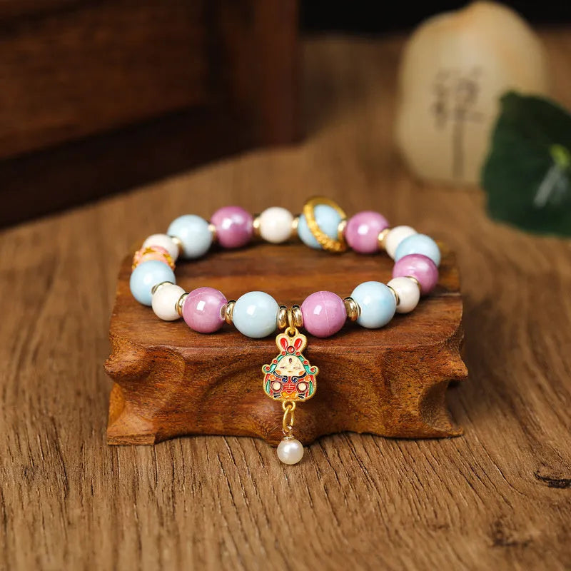 Grey porcelain glazed ceramic lucky rabbit charm bracelet on black elasticated cord