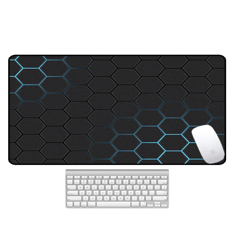 Large desk pad with printed pattern on a wooden desk, showing non-slip rubber base.
