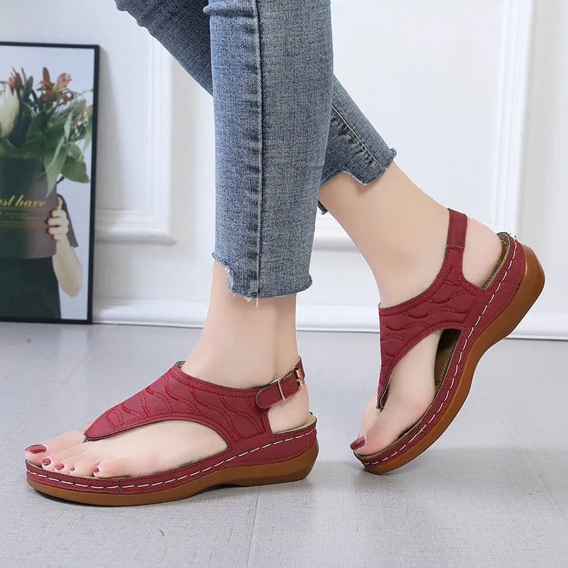 Women's black casual wedge heel sandals with an adjustable buckle strap on ankle.