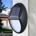 Black rectangular solar-powered LED wall light with a solar panel on top.