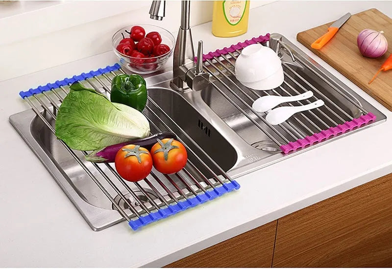 Folding stainless steel kitchen sink drying rack in red colour, shown extended for use.